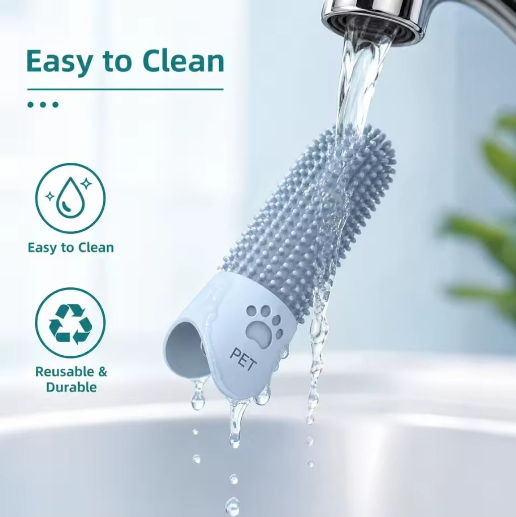 Silicone finger dog toothbrush under running water, showcasing its easy-to-clean design and durable material.